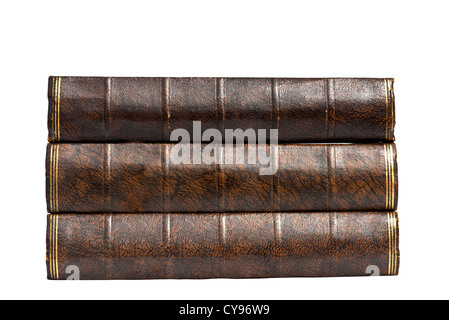 The spines of three brown hardback vintage retro antique books in a neat stack pile isolated isolation on white blanked blank Stock Photo