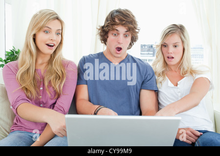 Shocked siblings at what is on the laptop Stock Photo