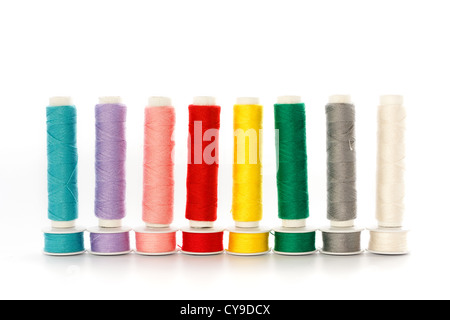 Multicolored sewing threads in a row isolated on white Stock Photo