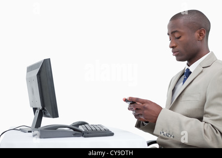 Side view of a businessman sending a text message Stock Photo