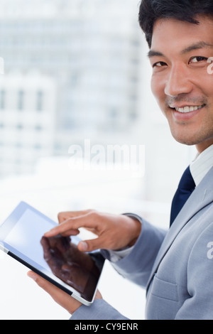 Portrait of a smiling office worker using a tablet computer Stock Photo