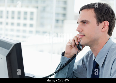 Young office worker on the phone Stock Photo