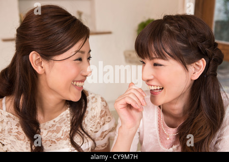 Two Young Women Talking and Laughing Stock Photo