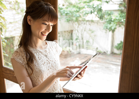Young Woman Looking at Tablet PC Stock Photo