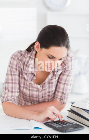 Woman using a calculator Stock Photo