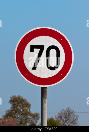 Traffic sign speed limit 70 against blue sky. Vertical shot Stock Photo