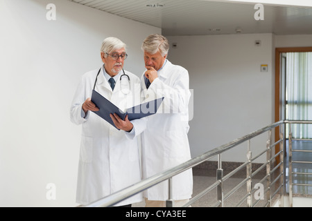 Doctors standing in the corridor talking Stock Photo
