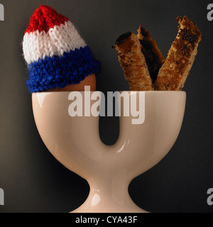 Breakfast boiled egg and soldiers of toast in a double eggcup Stock Photo