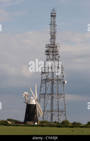 restored tower mill at Over, Cambridgeshire, contrasting with radio/television mast Stock Photo