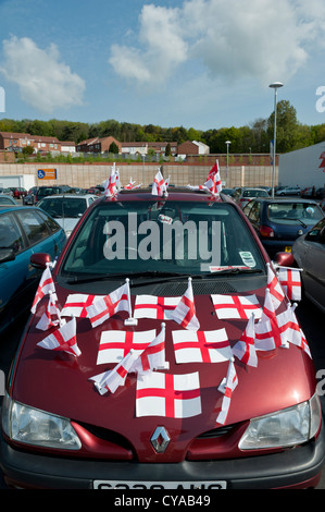 A parked red Renault car covered in the English cross of St George flags in preparation for the 2010 FIFA World cup. Stock Photo