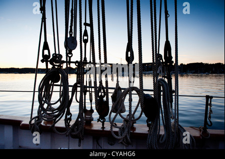 Details of the sail rigging on the historic tall ship 'Zodiac' with Puget Sound, Washington State in the background. Stock Photo