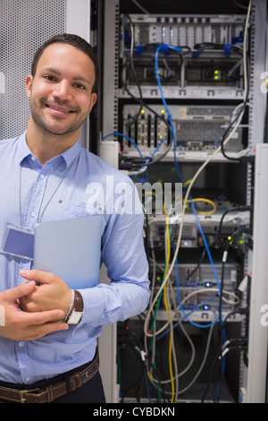 Man standing in front of servers Stock Photo