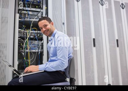 Smiling man working on the servers Stock Photo