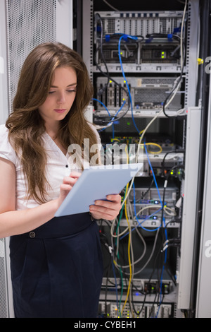 Woman checking servers using tablet pc Stock Photo