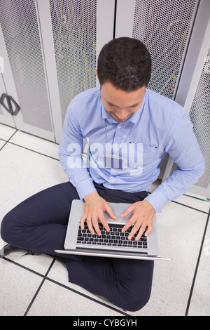 Man using his laptop in data center Stock Photo