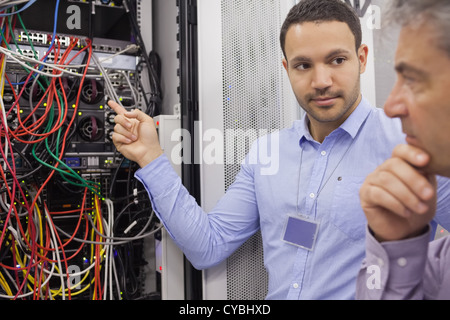 Two technicians looking at wiring Stock Photo