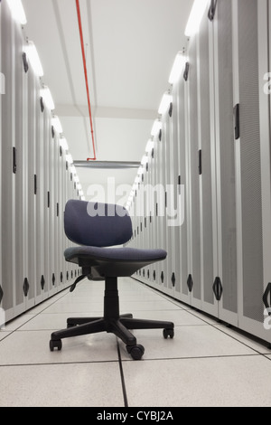 Chair in empty row of servers Stock Photo