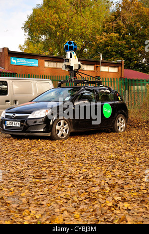 Black Google car with roof mounted camera equipment in car park left three quarter profile view Stock Photo