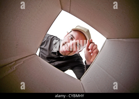 delivery man portrait and classic cardboard parcel Stock Photo