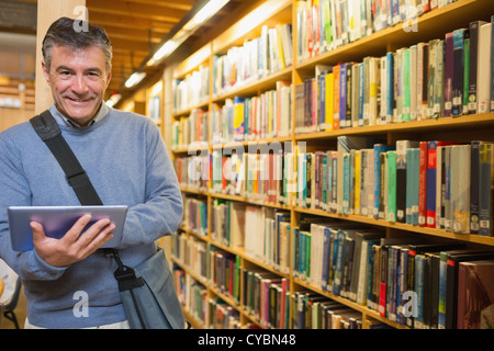 Man smiling while holding tablet pc Stock Photo