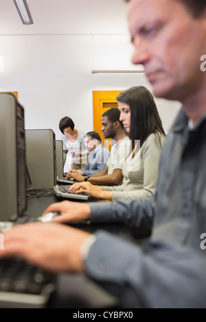 Woman helping her student with the computer Stock Photo