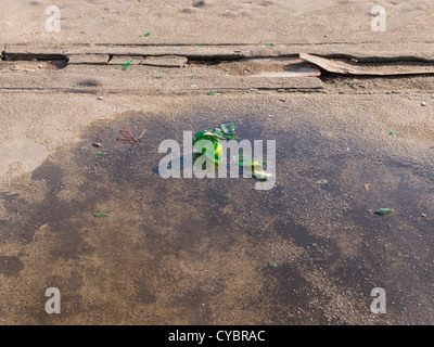 Broken glass bottle on the ground. Stock Photo