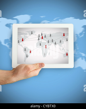 Hand showing a tablet PC displaying world map Stock Photo