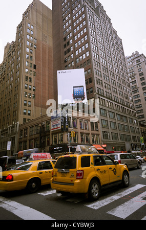 Advertising for the Apple iPad Mini on a billboard in Midtown Manhattan in New York Stock Photo
