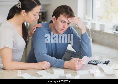 Worried couple looking over bills Stock Photo