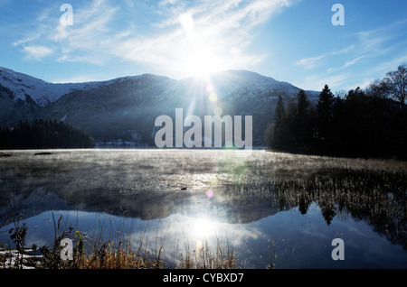 Sun going down over a cold mountaintop Stock Photo