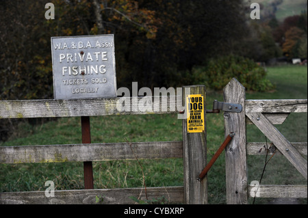 Private Fishing and farming signs on gates warning dog owners to take care with their animals in the Lake District UK Stock Photo