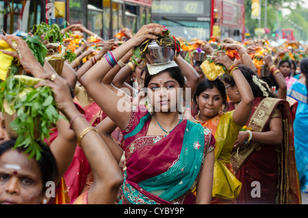 Tamil women carrying pots on their heads. The annual Chariot Festival of the Sri Kanaga Thurkai Amman Temple West Ealing London Stock Photo