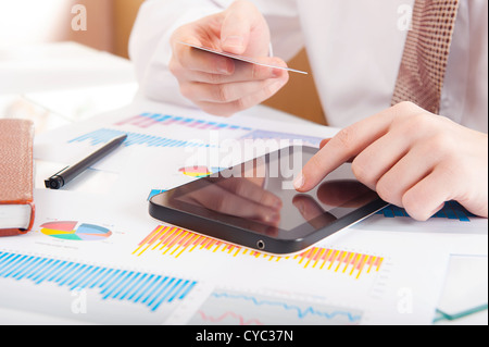Businessman using a credit card and digital tablet for buying on-line Stock Photo