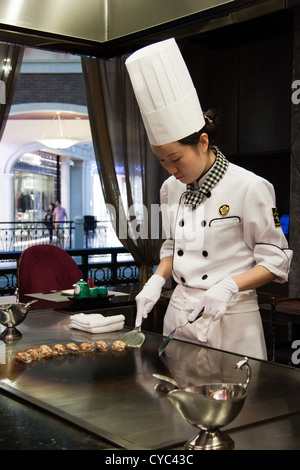 A chef in his open space kitchen in a Japanese restaurant in the Venetian hotel in Macau. Stock Photo