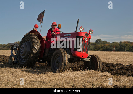 massey ferguson 65 tractor with driver and plough at ploughing match demonstration display show competition Stock Photo