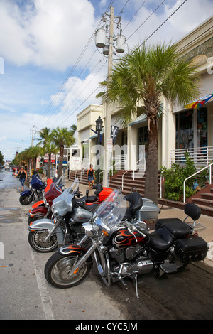 row of honda and harley davidson motorcycles parked in key west during bike week florida usa Stock Photo