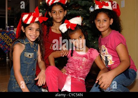 Four Latin girls under Christmas tree Stock Photo