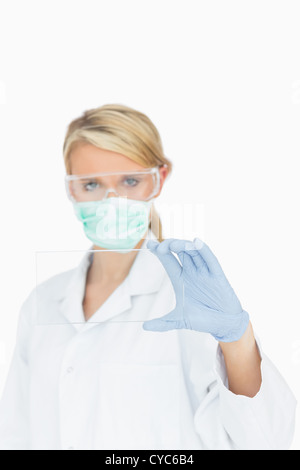 Surgeon looking through clear pane Stock Photo