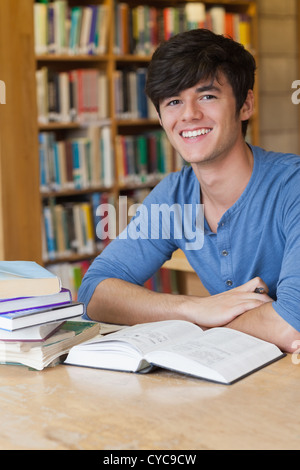 Smiling student sitting at her desk Stock Photo - Alamy