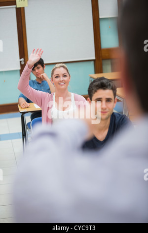Woman asking question in class Stock Photo