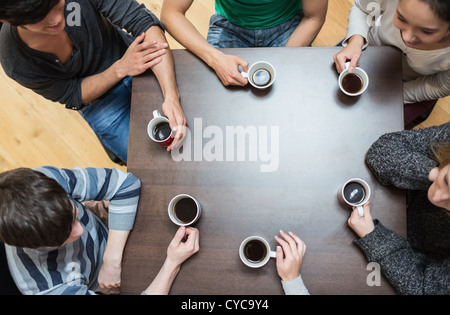 People sitting around table drinking coffee Stock Photo