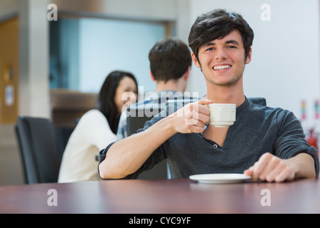 Man sitting holding cup of coffee Stock Photo