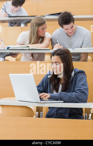 Student using laptop in lecture Stock Photo