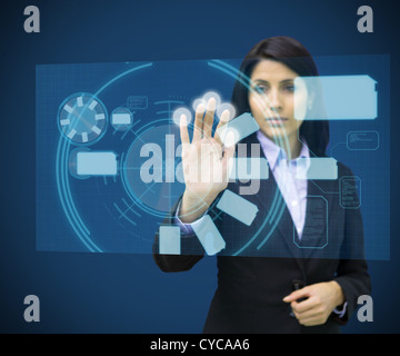 Concentrate woman touching a hologram Stock Photo