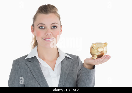 Businesswoman holding a piggy bank Stock Photo
