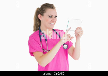 Doctor selecting something on clear pane Stock Photo