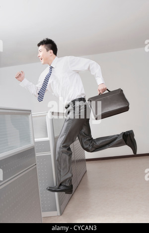 Businessman running with briefcase,side view Stock Photo