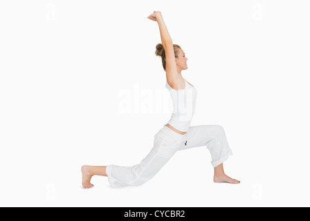 Joyful woman in a lunge pose with hands in Anjali Mudra enjoys a ...