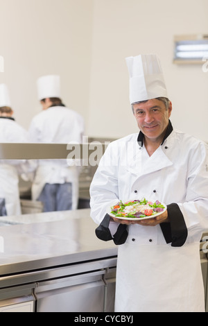 Chef showing his salad in the kitchen Stock Photo
