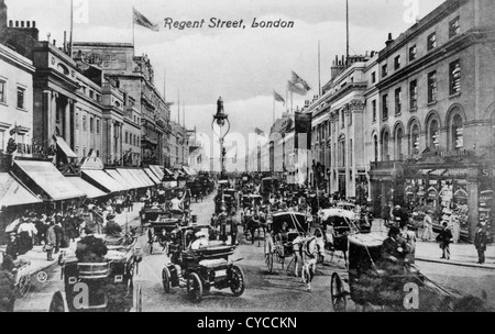 Regent Street Victorian London UK 1880s 1890s  (Centre) The motorcar or horseless carriage with woman passenger in her large fashionable hat. The car is probably a Daimler, but one of the German built Canstatt Daimlers, not a product of the Coventry based British company. It is being driven by the top hated gent sitting high over the front wheels. Traffic, hansom cabs horse drawn carriages and  crowds of people going shopping. Traffic congestion rush hour central London 1890s. On the right the women are outside 'F.S.Goss The Pharmacy Stores'  Circa 1895 Stock Photo